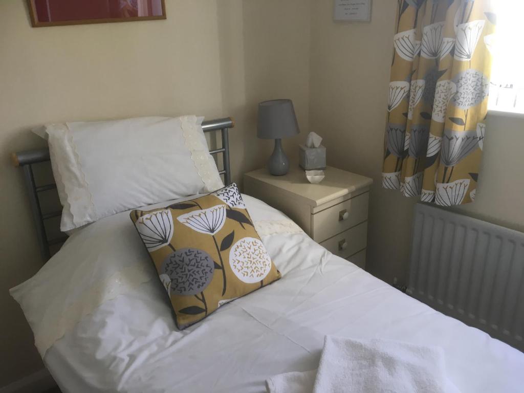 a bedroom with a bed with a pillow on it at Bridge End in Northallerton