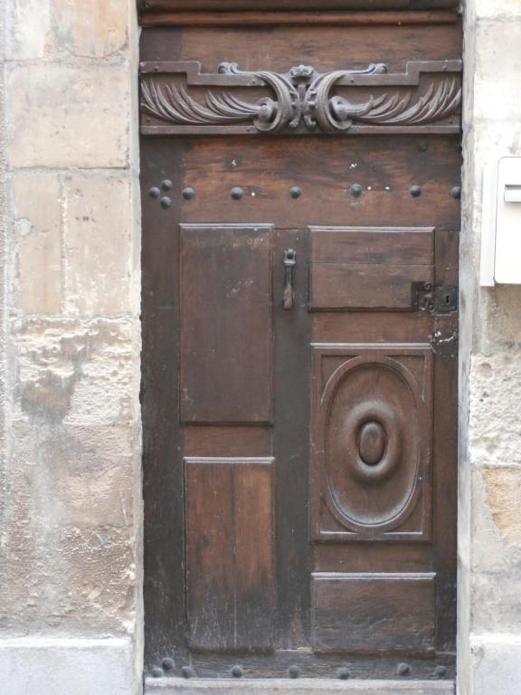 an old wooden door in a stone building at Le Logis XVIIème in Moulins