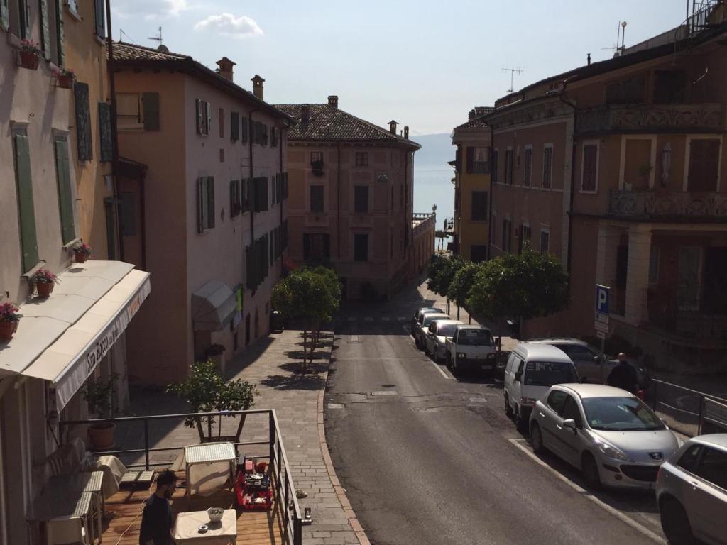a city street with cars parked on the side of the road at La Casa di Anna in Gargnano