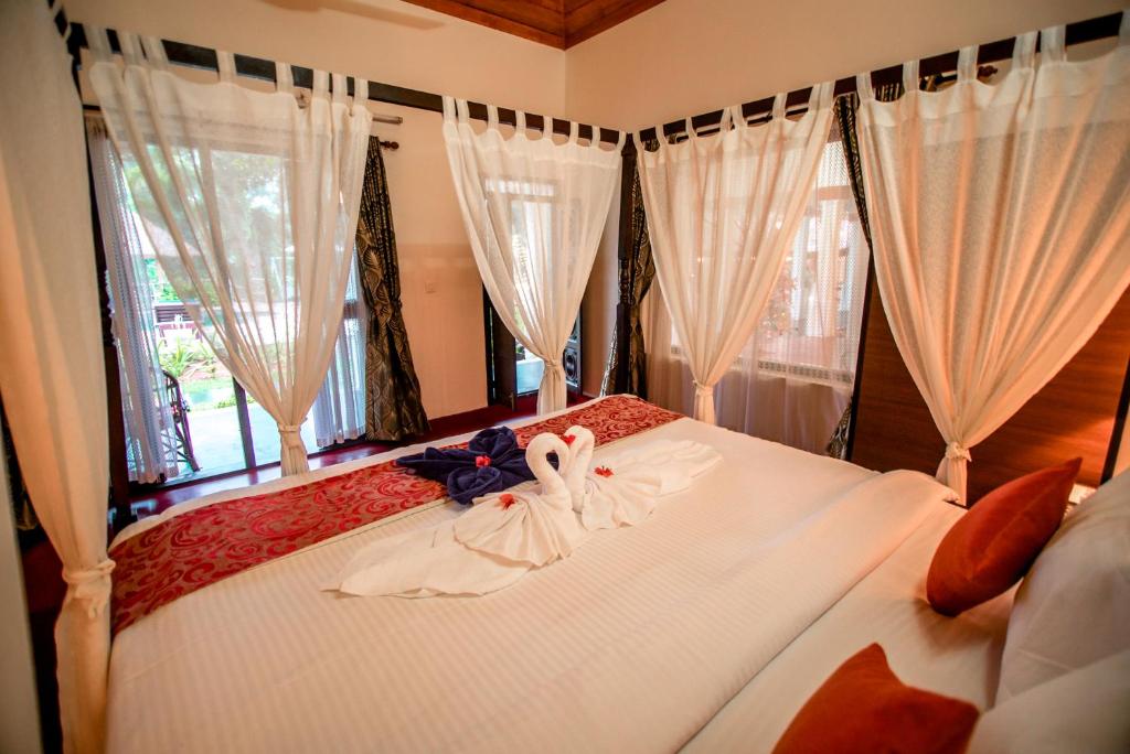 Postel nebo postele na pokoji v ubytování Flamingo Boutique Hotel & Ayurvedic spa