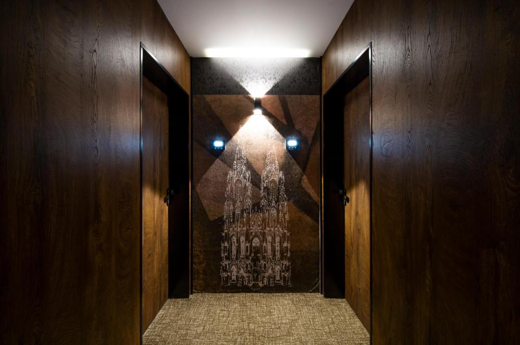 a hallway with wooden walls and a light on the wall at Amsterdam Hotel in Belgrade