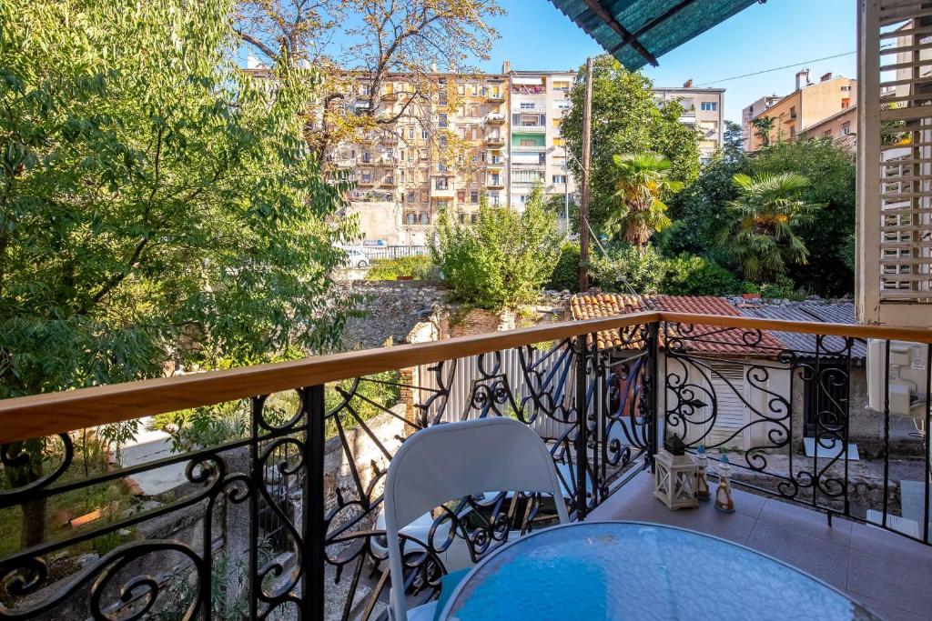 a balcony with a table and chairs on a balcony at Julia apartments in Rijeka