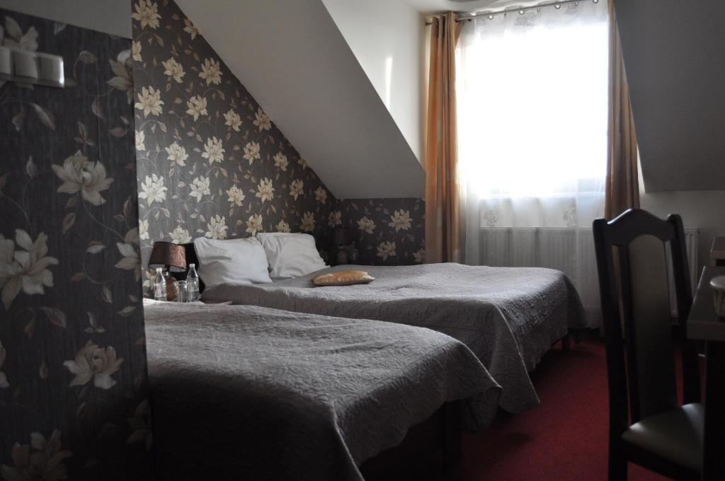 Postel nebo postele na pokoji v ubytování Prymus