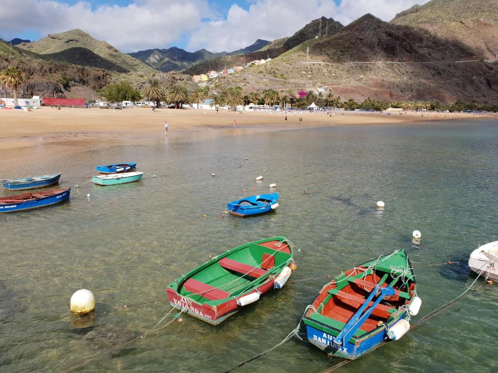 a group of boats in the water near a beach at Las Teresitas Apartment in San Andrés