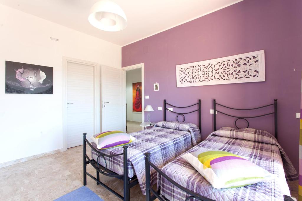 Łóżko lub łóżka w pokoju w obiekcie B&B I Poeti
