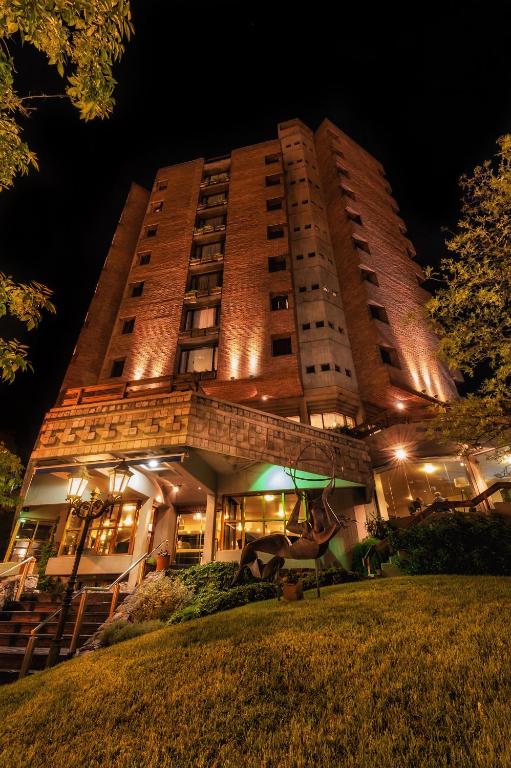 a tall building with lights on it at night at Hotel de la Cañada in Córdoba