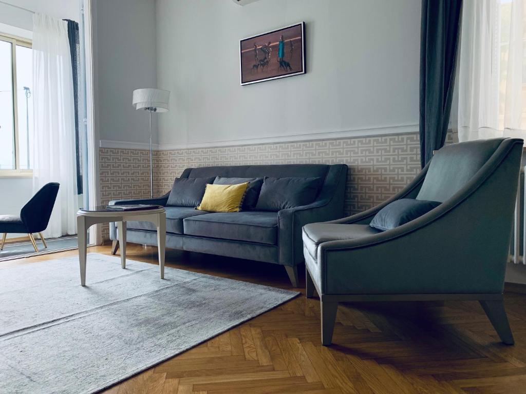 a living room with a couch and a table at Villa Bagatelle - Luxury apartment in Nice