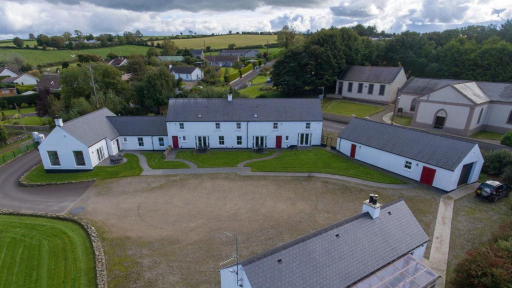 an aerial view of a large white house with a yard at Foyle Cottage in Strabane