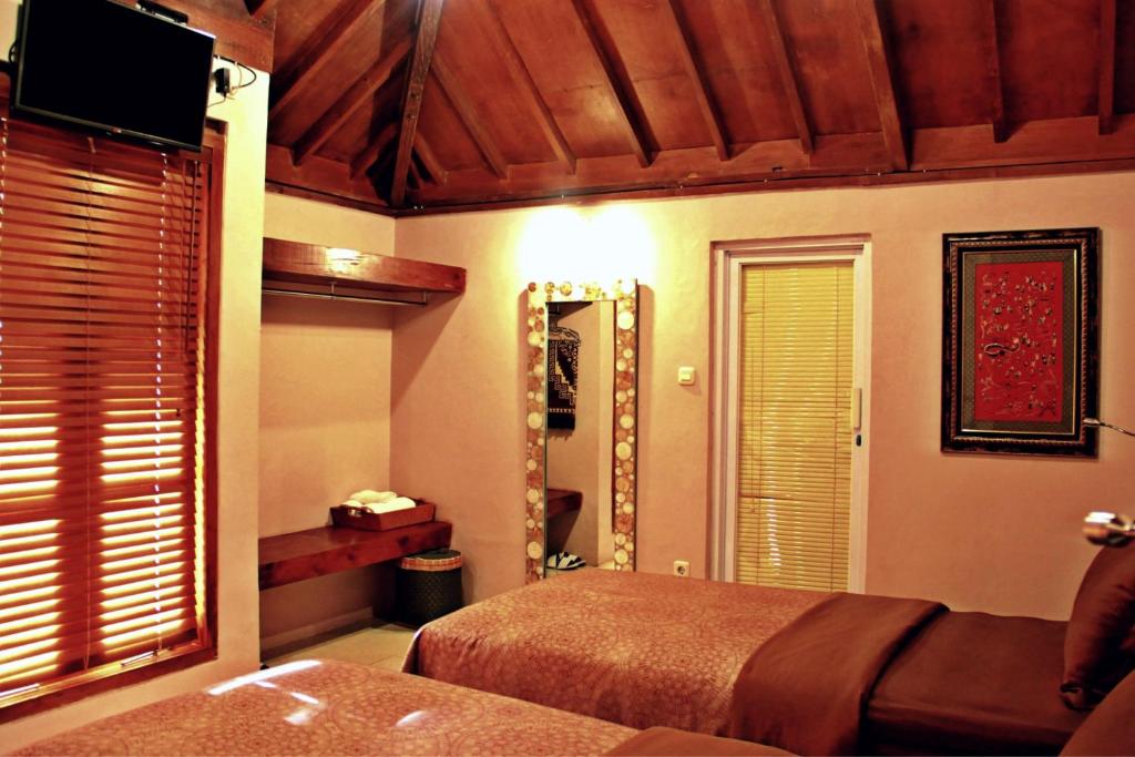 Postel nebo postele na pokoji v ubytování Tegal Panggung Guest House