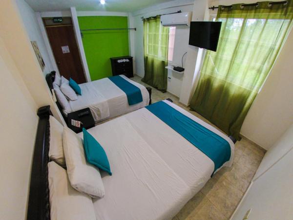 Postel nebo postele na pokoji v ubytování Casa Royal Palm Inn