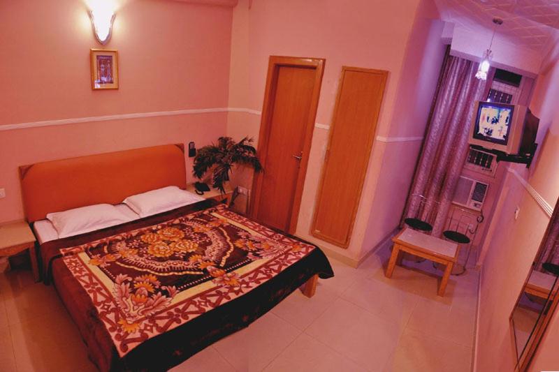 Postel nebo postele na pokoji v ubytování Hotel Queen