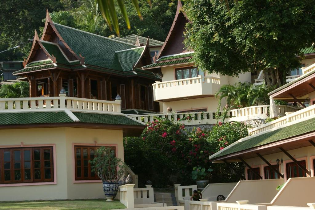 a large house with a green roof at Prince Edouard Apartments & Resort SHA extra plus in Patong Beach