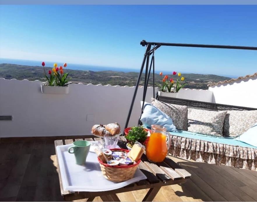 a tray of food on a table on a balcony at Chic & Beauty in Agrigento