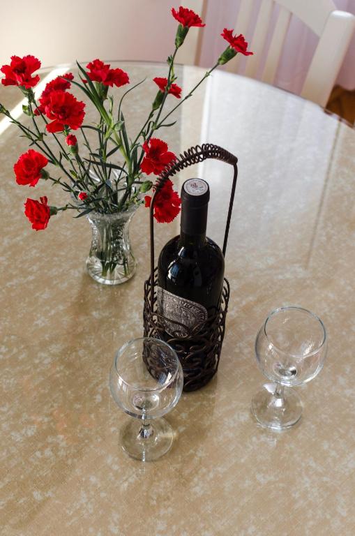 a table with a bottle of wine and two glasses at Apartmani Marko in Makarska