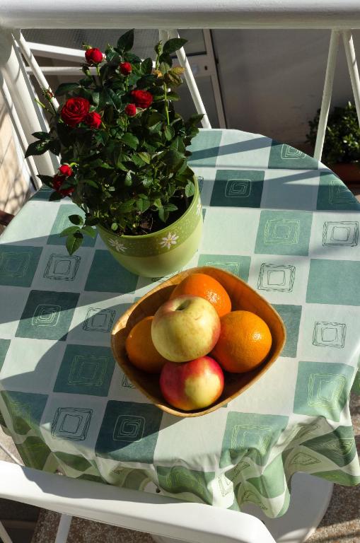 a bowl of fruit on a table with a plate of fruit at Apartmani Marko in Makarska