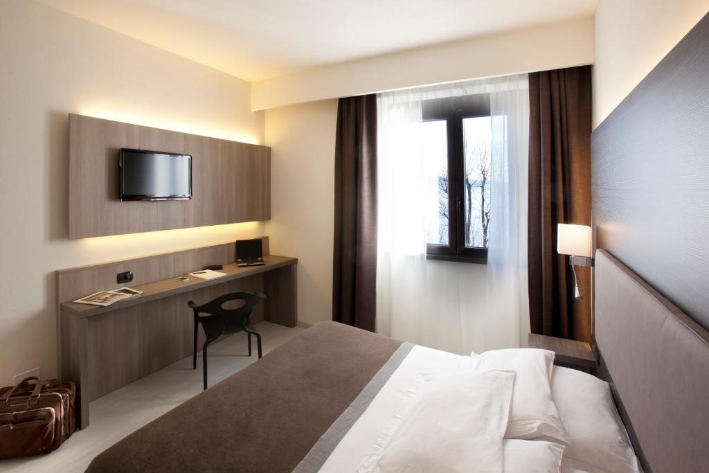Una cama o camas en una habitación de Hotel Giardino