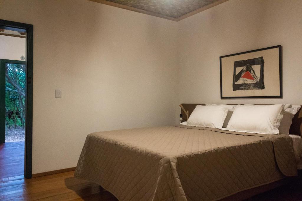 Säng eller sängar i ett rum på Pousada Villa Madorna