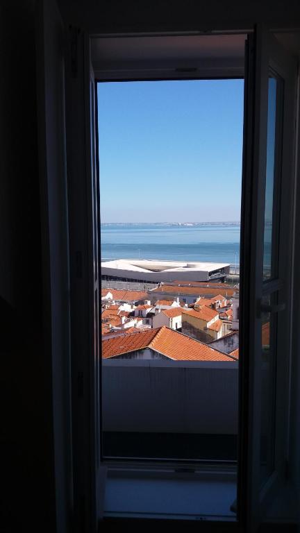 a view of a city from a window at Miradouro de Santa Luzia in Lisbon