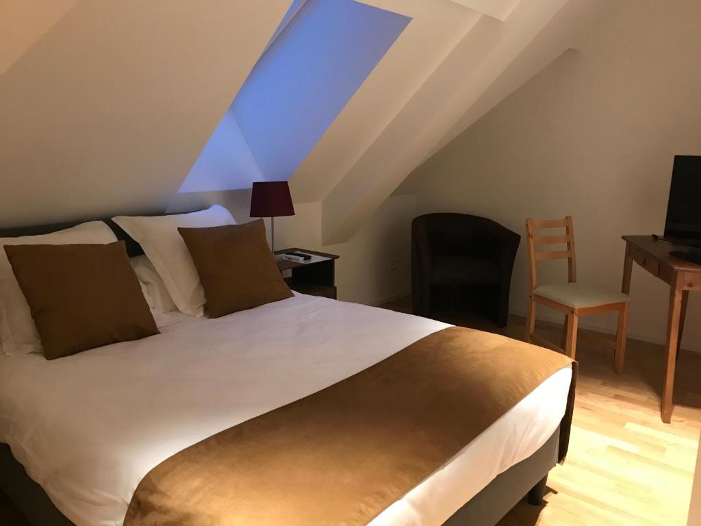 Postel nebo postele na pokoji v ubytování L’Auberge de Mézières