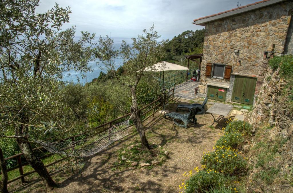 an external view of a stone house with a patio at Il Sole di Valletonda Holiday House in Corniglia