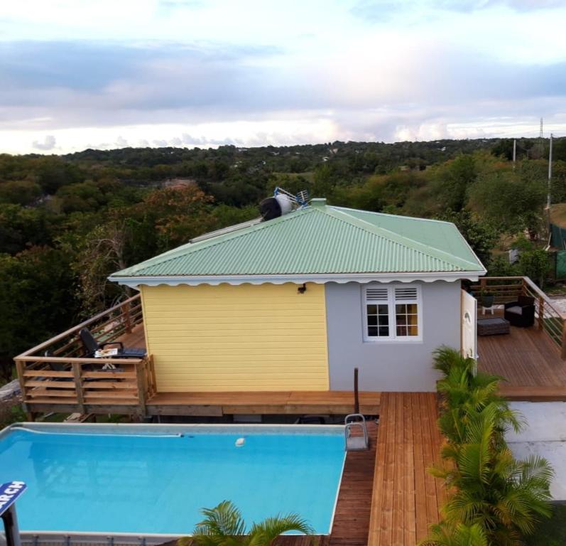 a house with a swimming pool in front of it at LES MULTIPLIANTS in Le Moule