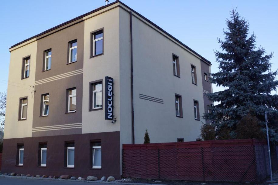 a building with a sign on the side of it at Noclegi AVATAR Radom in Radom