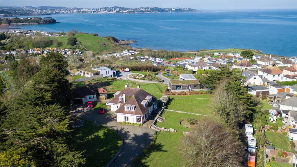an aerial view of a village with houses and the ocean at The Stoep in Paignton