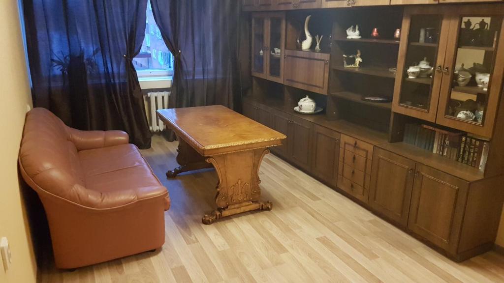 a living room with a couch and a table and a chair at Adart Apartment in Narva