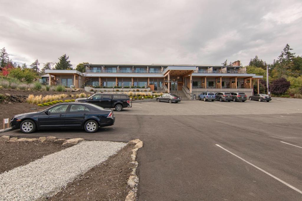 a parking lot with cars parked in front of a building at Harbour House Hotel in Ganges