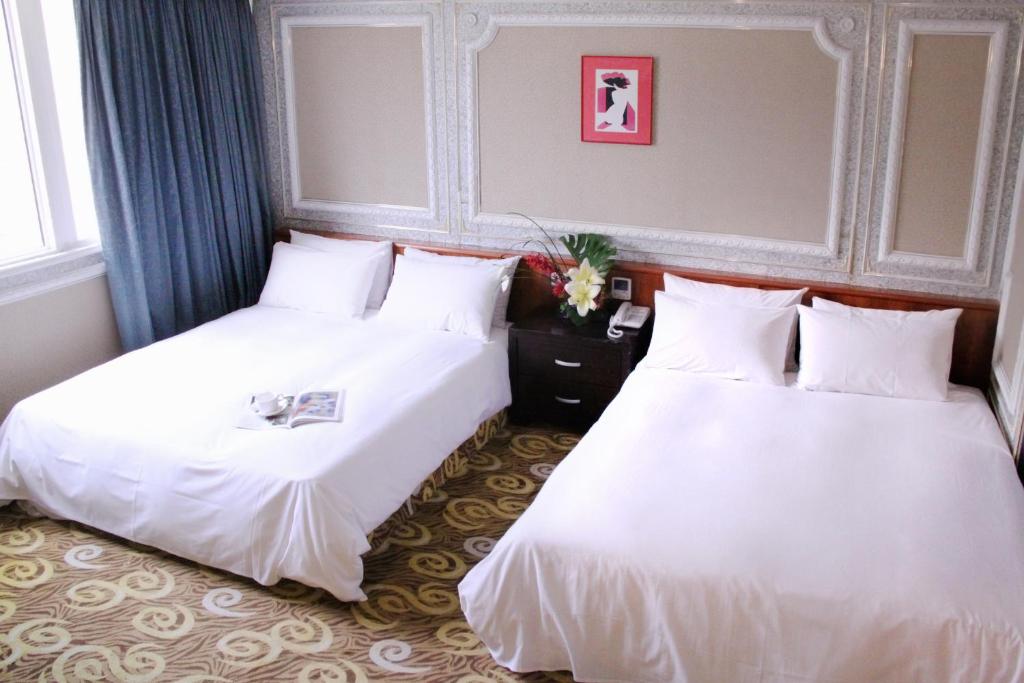 Postel nebo postele na pokoji v ubytování 貴都飯店-Crystal Hotel Taipei