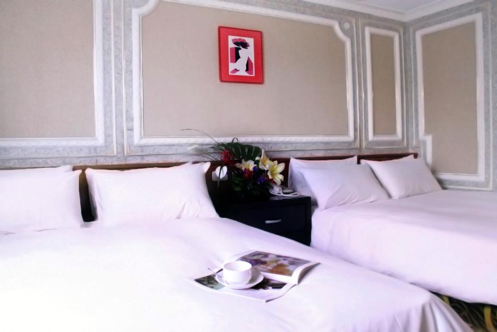 Postel nebo postele na pokoji v ubytování 貴都飯店-Crystal Hotel Taipei