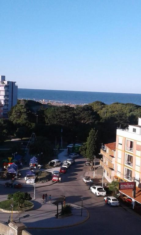 a street with cars parked in a parking lot next to the ocean at Dpto AR in San Clemente del Tuyú