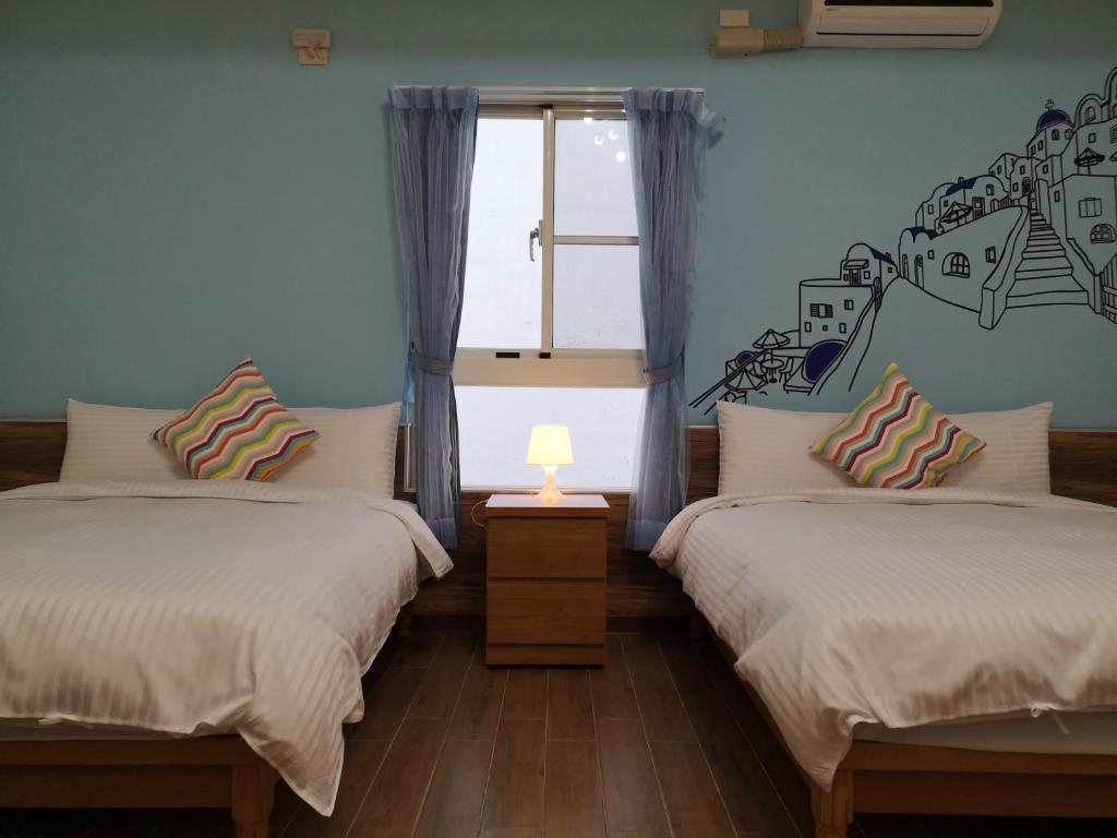 Postel nebo postele na pokoji v ubytování Hengchun Inn