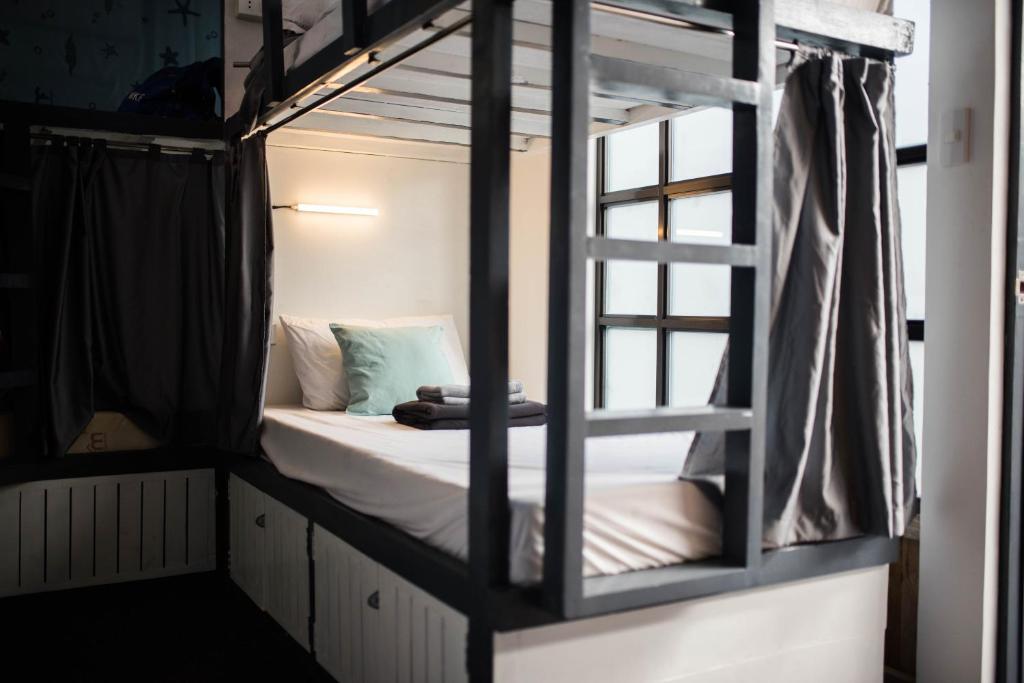 a bunk bed with a ladder in a room at Avisala Hostel Coron in Coron