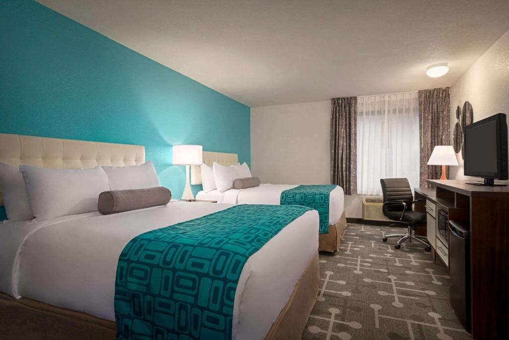 a hotel room with two beds and a television at Howard Johnson by Wyndham Appleton in Appleton