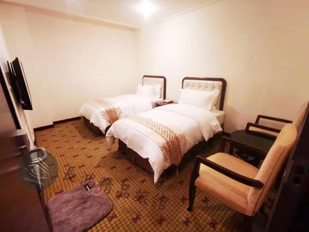 Postel nebo postele na pokoji v ubytování Chang Hong Hotel
