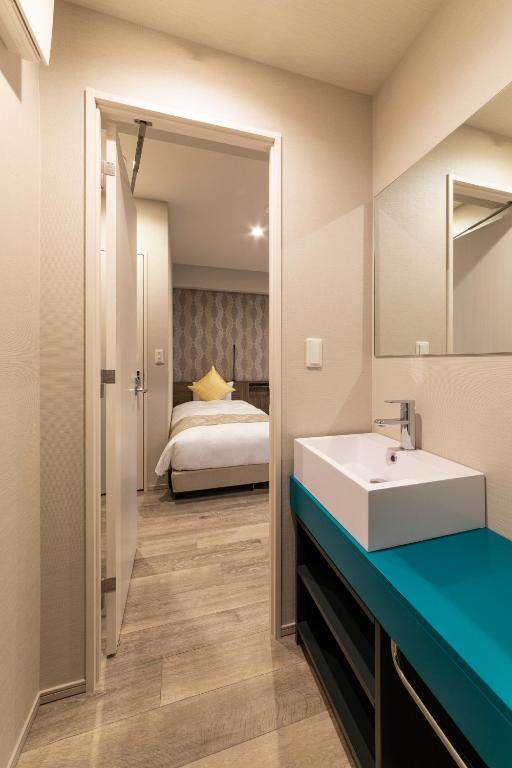 Postel nebo postele na pokoji v ubytování SARASA HOTEL Dotonbori