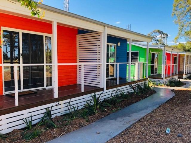 a row of colorful houses on a street at Huskisson Beach Resort in Huskisson