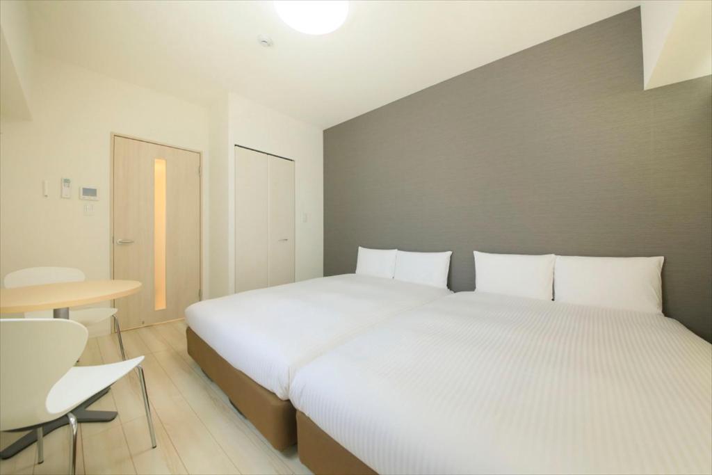 Postel nebo postele na pokoji v ubytování Bay Hotel Urayasu-ekimae