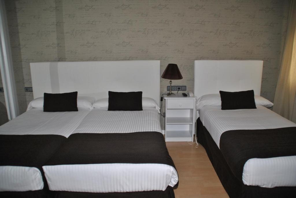Postel nebo postele na pokoji v ubytování Hotel Junquera