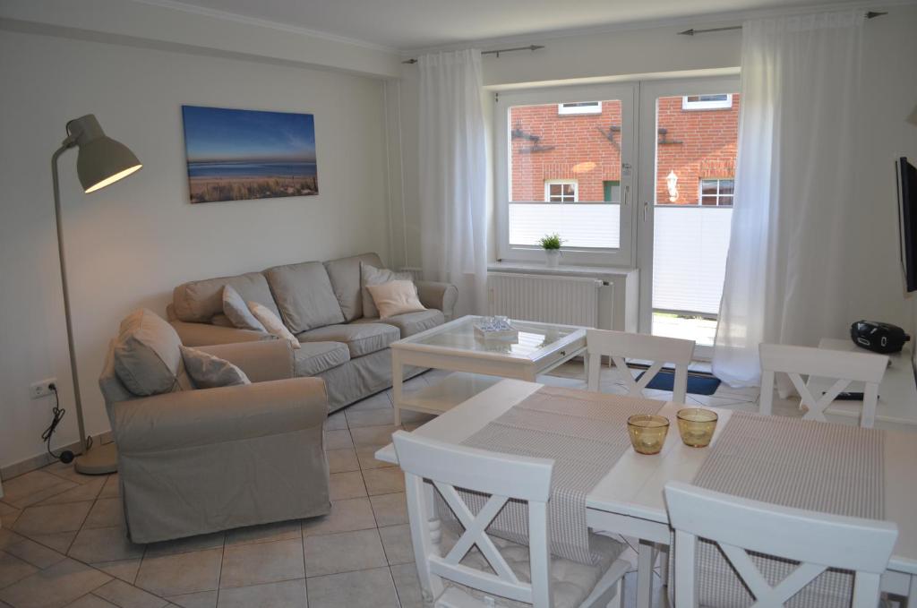 a living room with a couch and a table at Ferienhof Felix in Scharbeutz