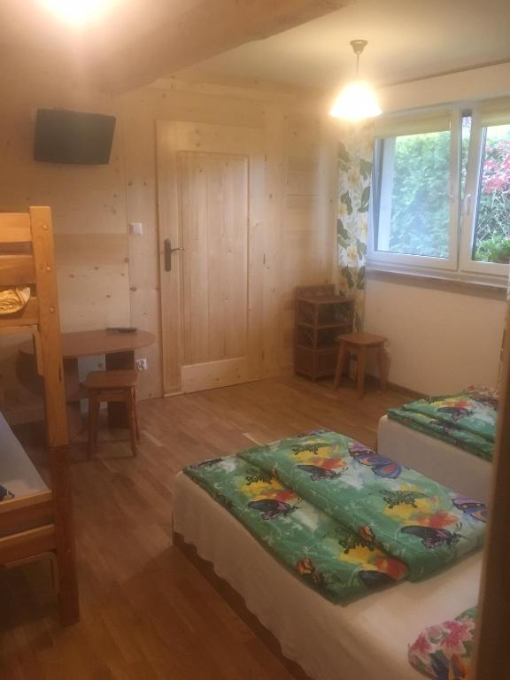 Posteľ alebo postele v izbe v ubytovaní Domek pod Maciejową