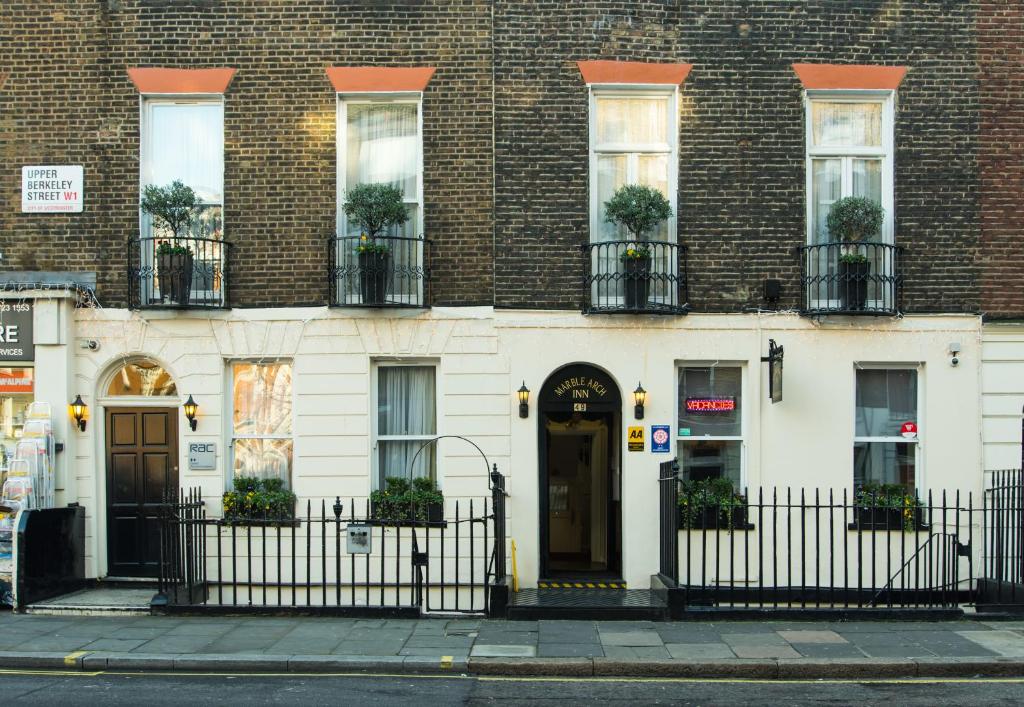 a building with a black fence in front of it at Marble Arch Inn in London