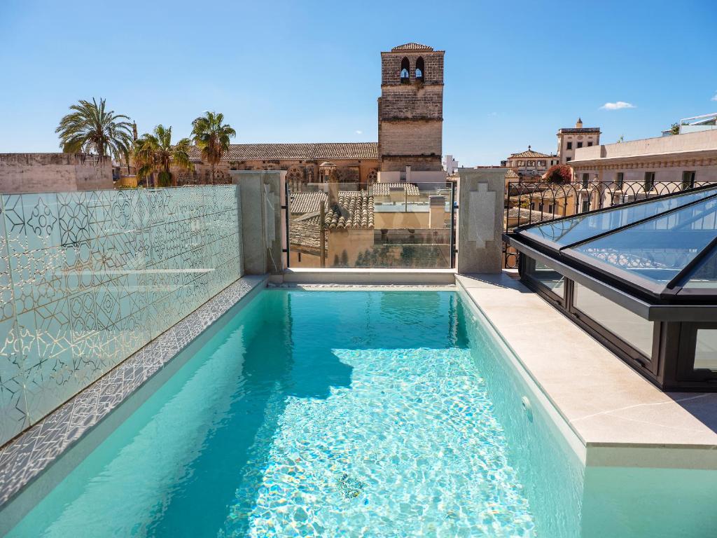 a swimming pool on the roof of a building at Hotel Gloria de Sant Jaume in Palma de Mallorca