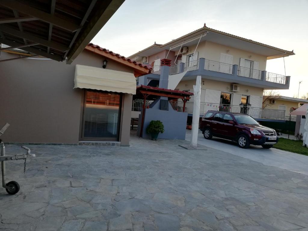 a car parked in front of a house at Rea's House Vrachati in Vrachati