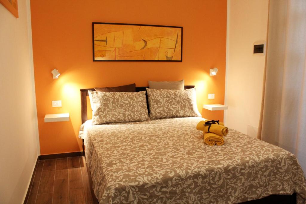 a bedroom with a bed with a teddy bear on it at Il Giardino di Laura Private Rooms Mondello in Mondello