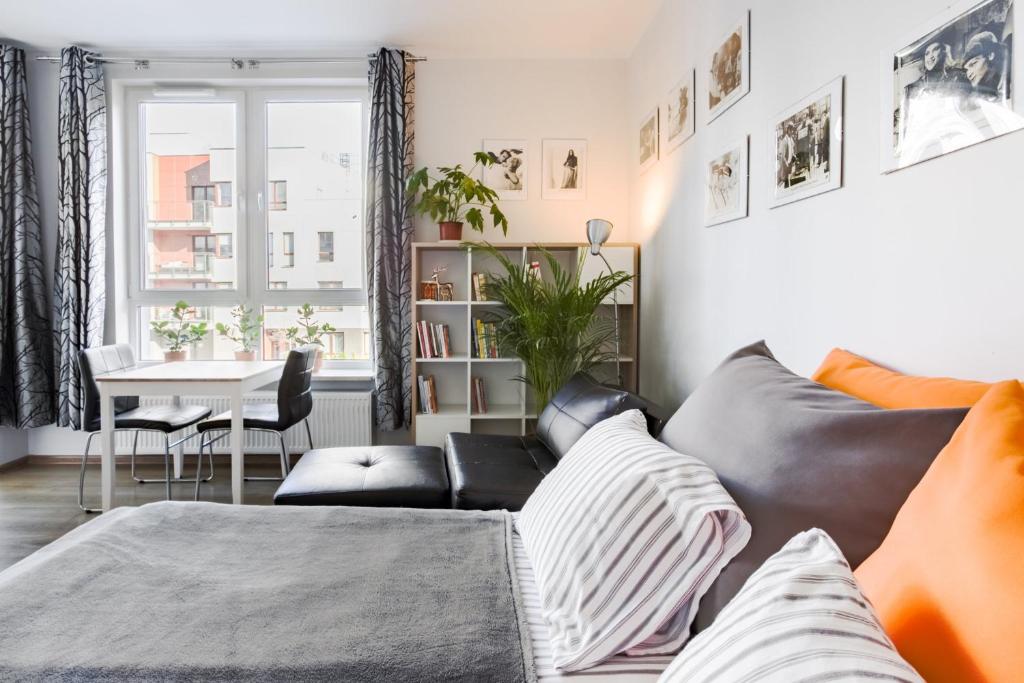 a living room with a couch and a table at Airport Residence ORANGE in Warsaw