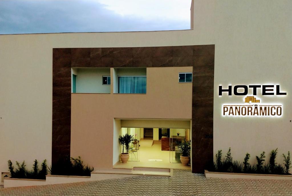 a hotel sign on the side of a building at Hotel Panorâmico in Carmo do Paranaíba