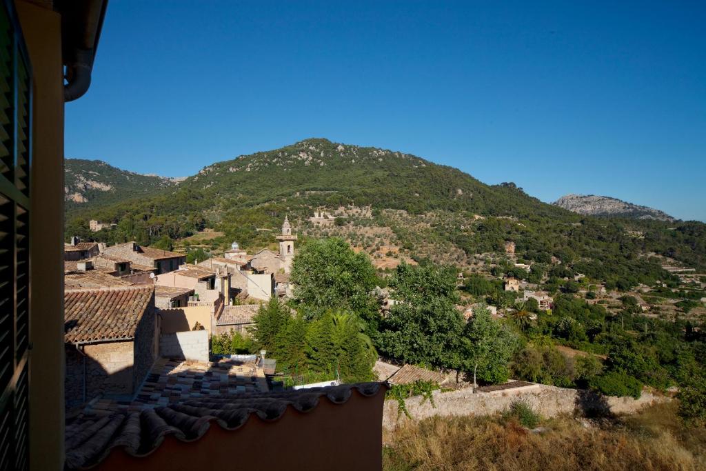 a large stone building with a view of a mountain range at Es Petit Hotel de Valldemossa in Valldemossa