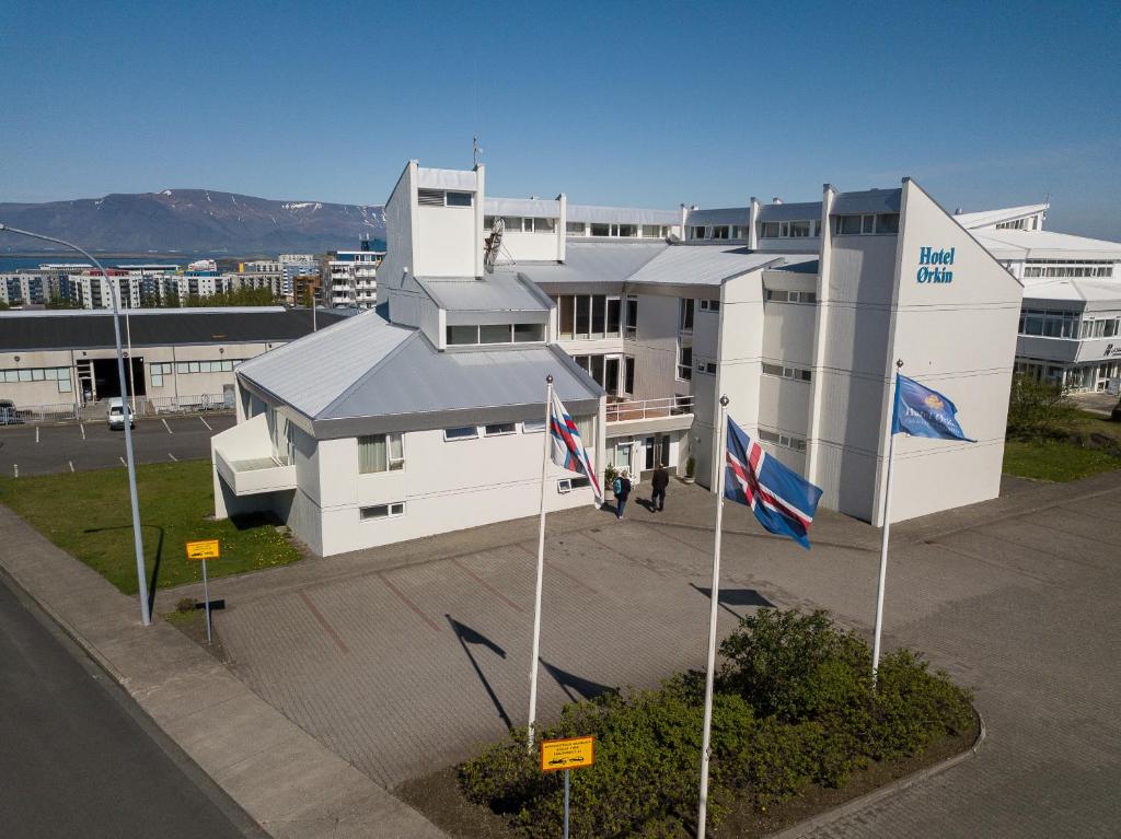 a white building with flags in front of it at Hotel Orkin in Reykjavík